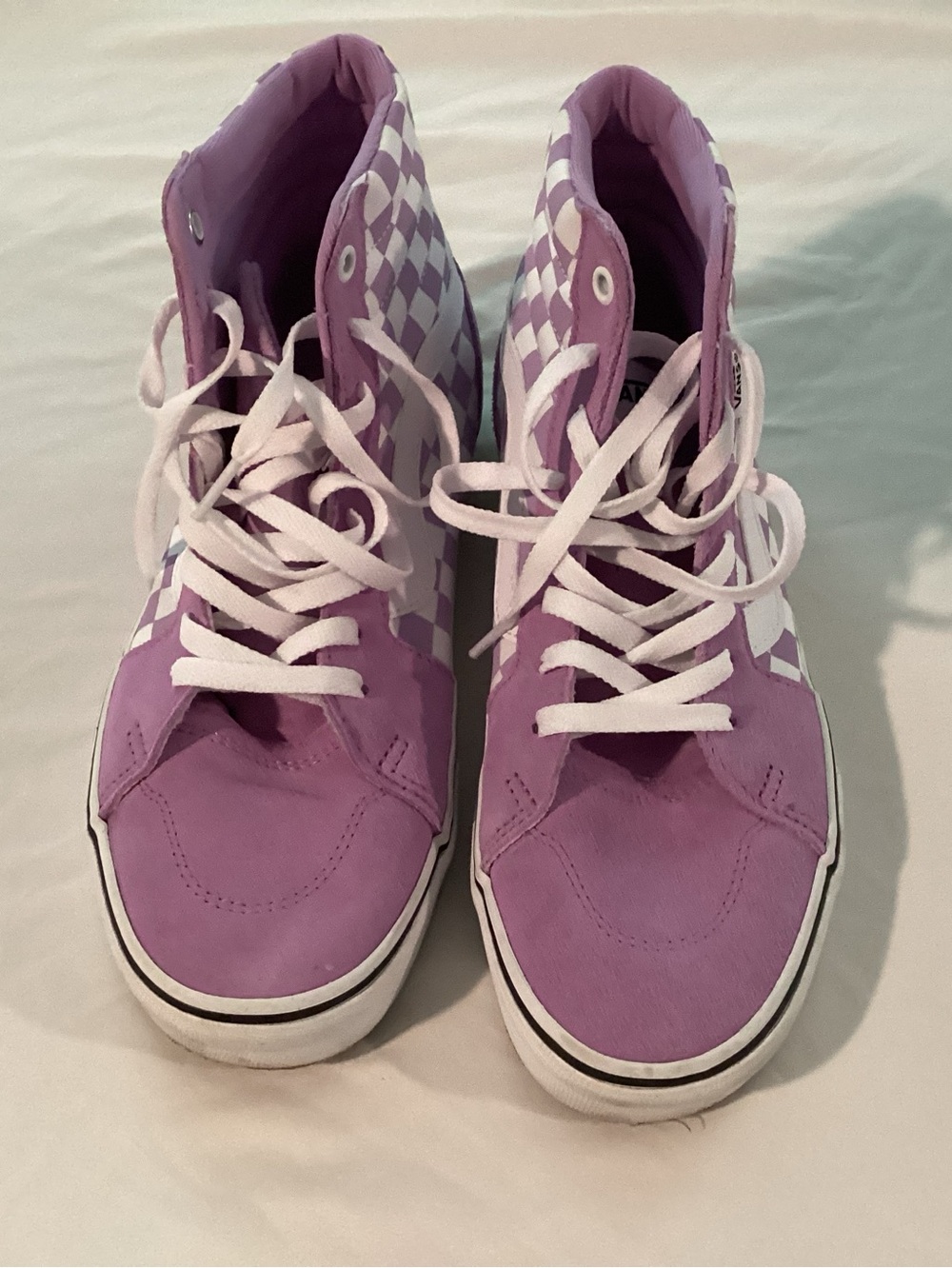Purple and white high top Vans shoes